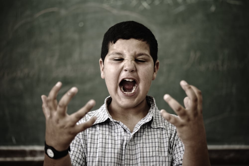 Furious mad pupil at school yelling
